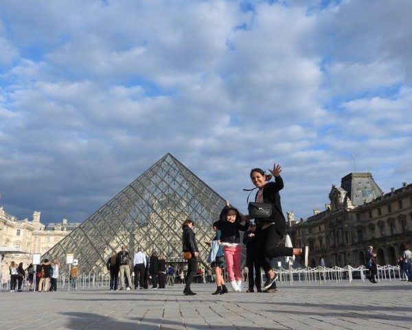Lara and Mom jumping at the Louvre museum